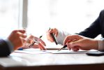 Banking business or financial analytics desktop with accounting charts, pen and glasses